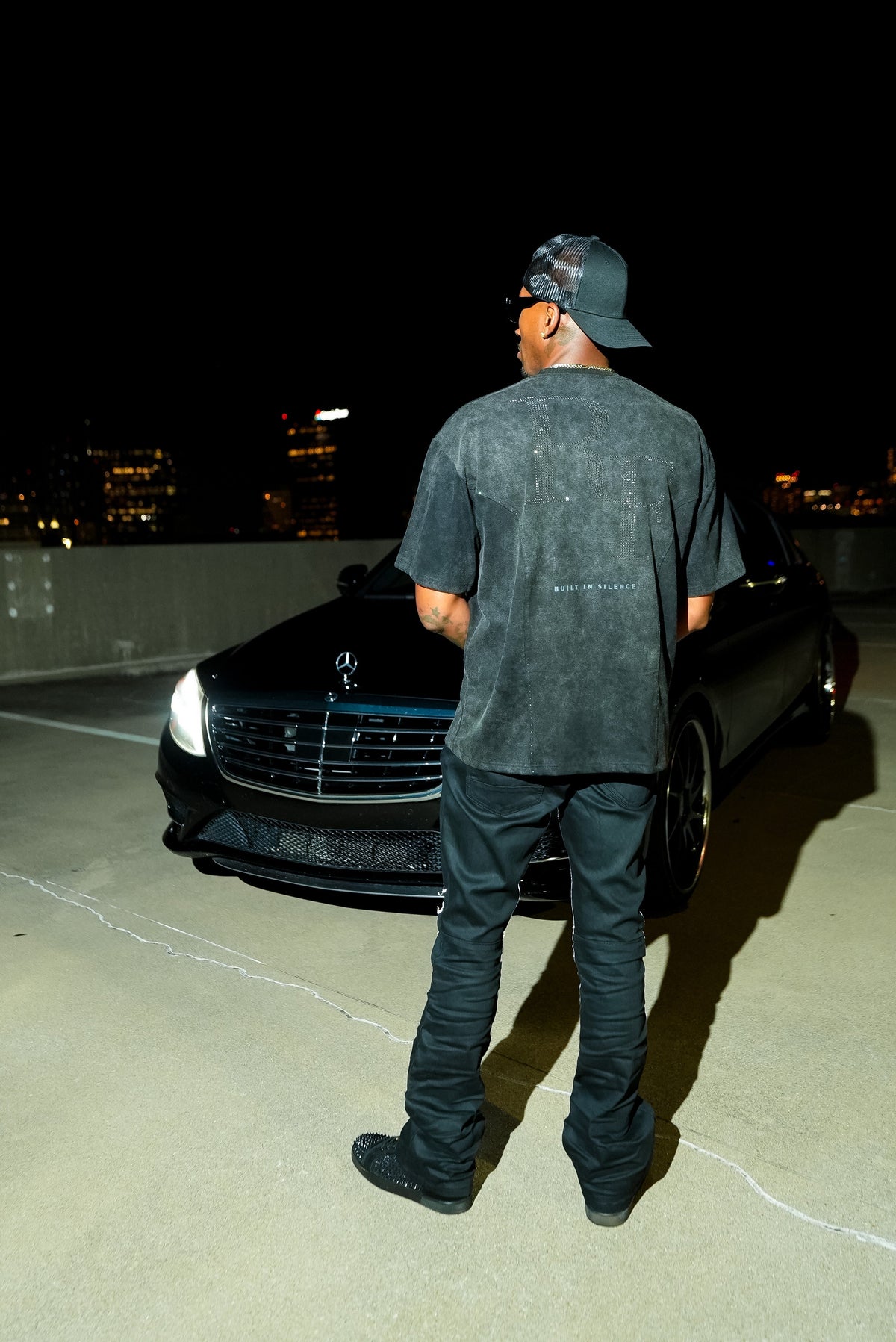 Silent Construct Signature Tee — back full-length model shot with BUILT IN SILENCE back graphic.