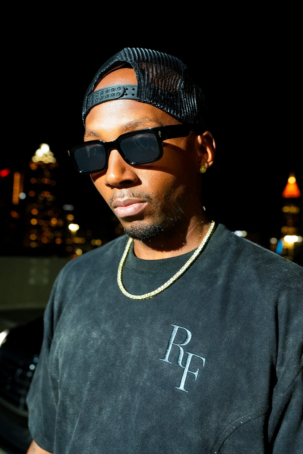 Silent Construct Signature Tee — front close-up of the tonal RF chest embroidery on the washed-black wash, worn.