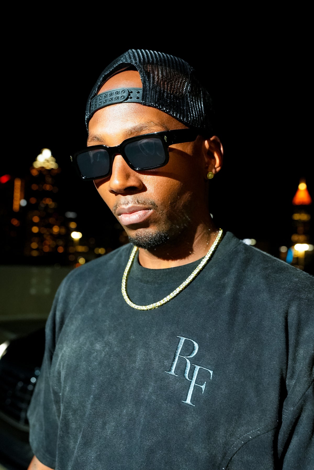 Silent Construct Signature Tee — front close-up of the tonal RF chest embroidery on the washed-black wash, worn.